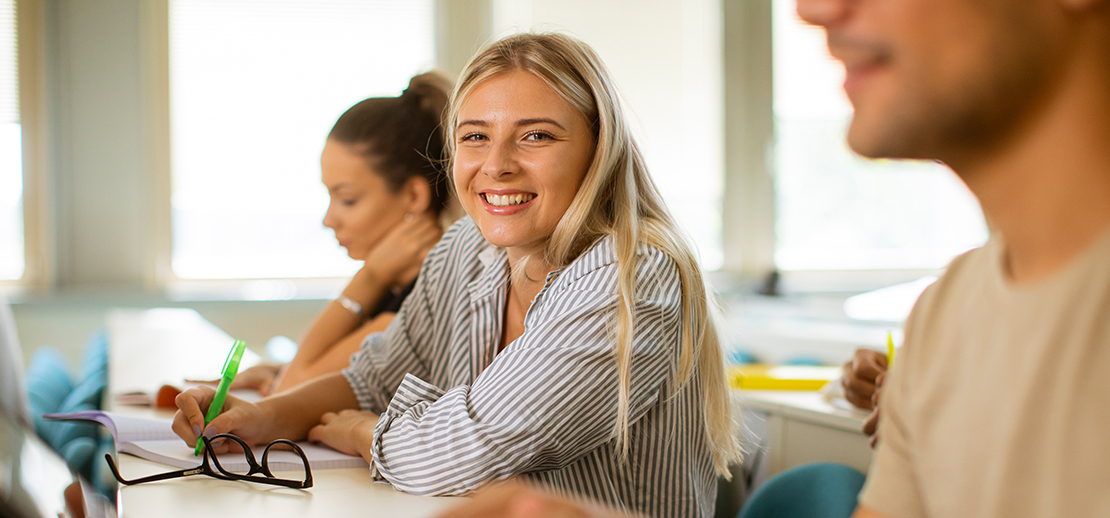 female student in class diagnosed with adhd smiling after lu caps enrichment services